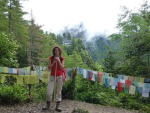 Tourist standing by prayer flags in Bhutan