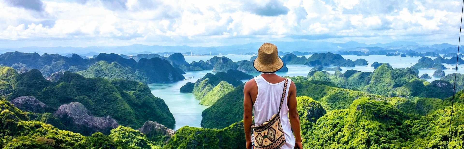 Vietnam Tourist looking over limestone cliffs and bays