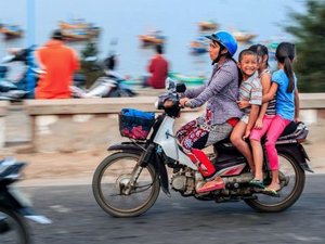 Family of four riding on one motorcycle