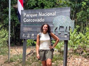 Woman stood next to Corcovado sign