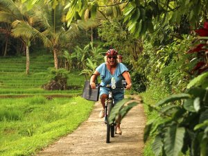 Woman on bike cycling through Sanur
