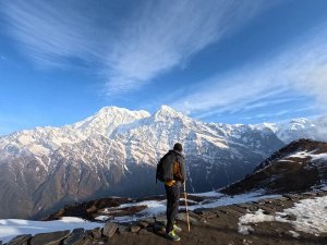 Man facing snowclad mountain peak in Nepal